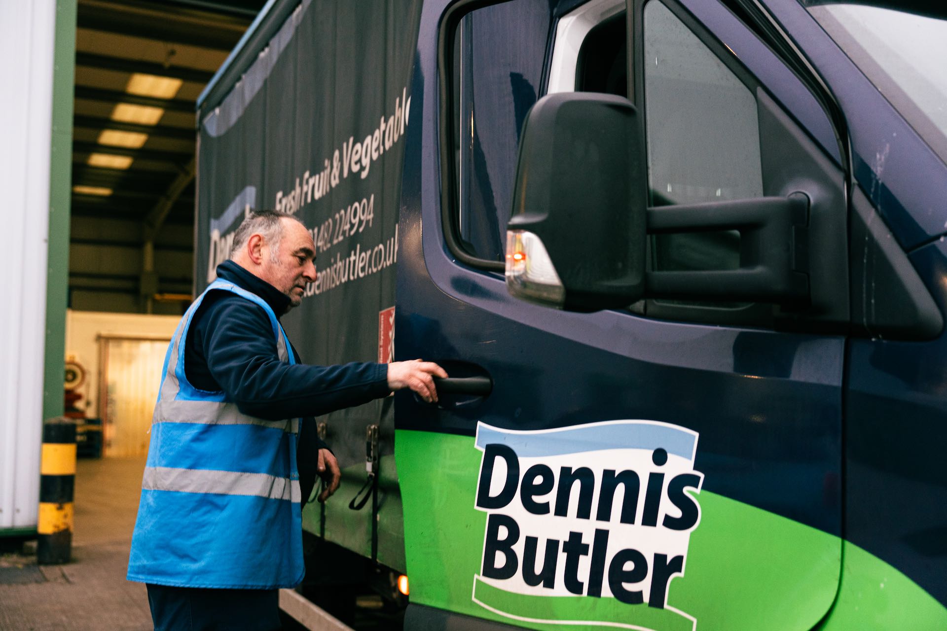 man gettig into dennis butler delivery vehicle